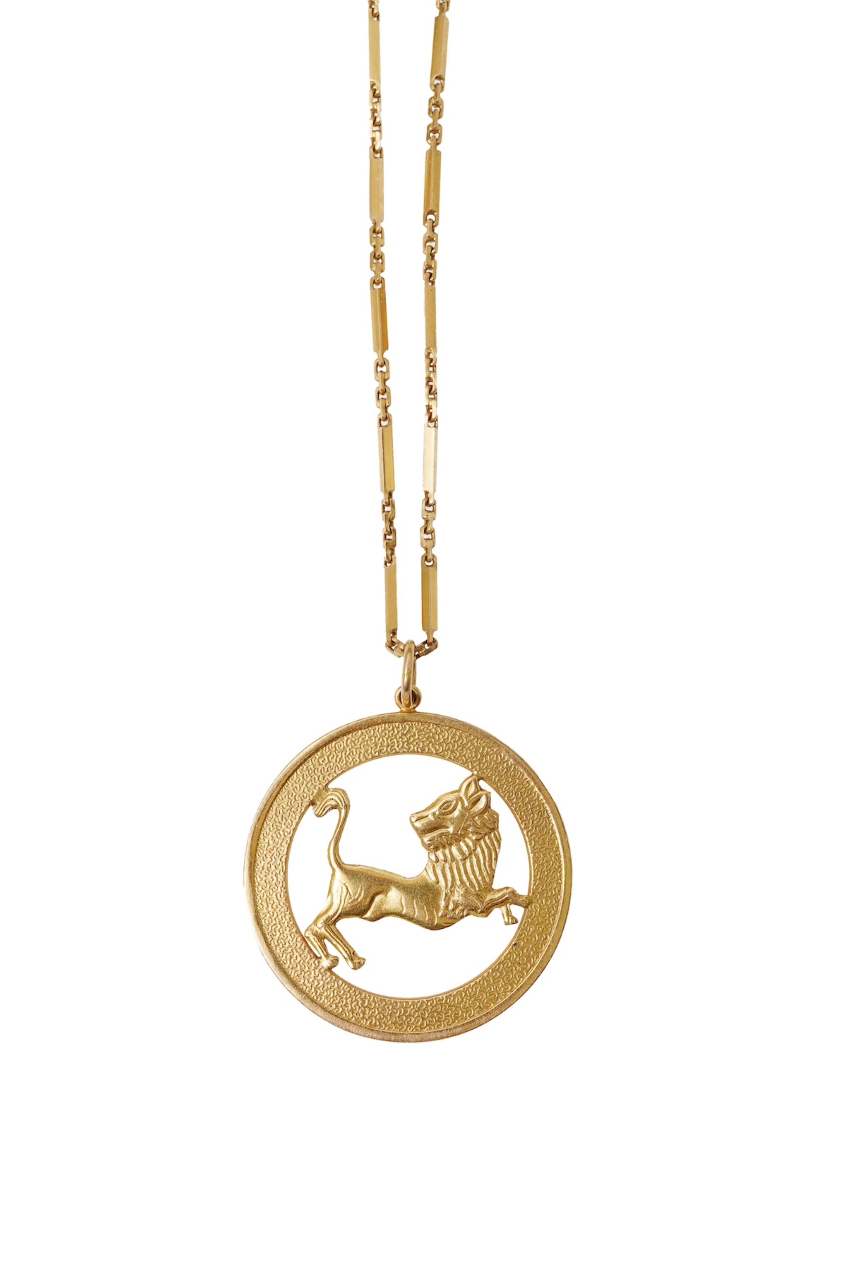 A gold zodiac pendant, mid 20th century